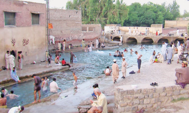 People take a dip in Junglekhel springs. — Dawn People take a dip in Junglekhel springs. — Dawn