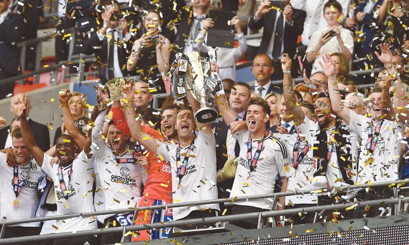 LONDON: Fulham players celebrate with the trophy after winning the Championship play-off final against Aston Villa at the Wembley Stadium.—Reuters LONDON: Fulham players celebrate with the trophy after winning the Championship play-off final against Aston Villa at the Wembley Stadium.—Reuters