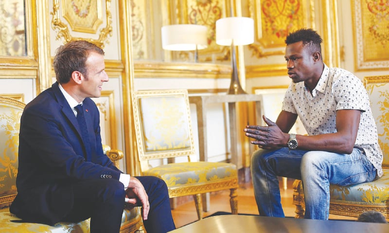 Paris: French President Emmanuel Macron (left) meets Mamoudou Gassama from Mali at the Elysee Palace on Monday.&mdash;Reuters