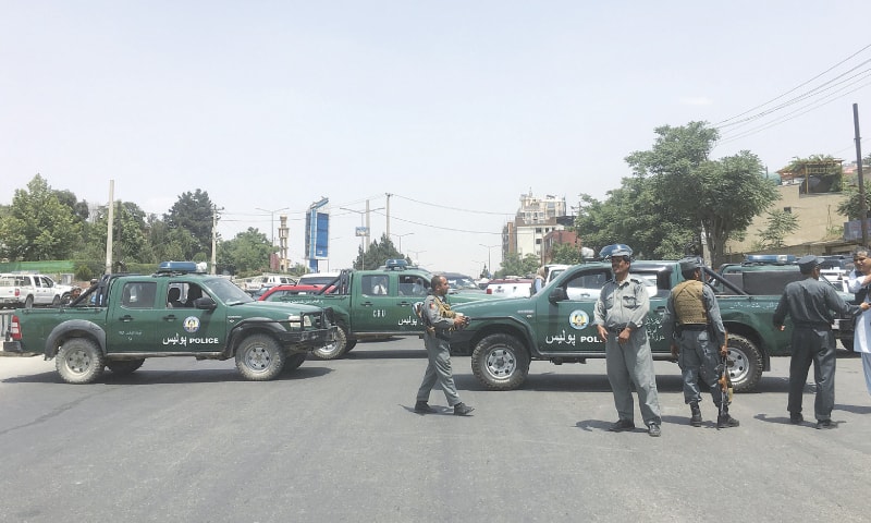 KABUL: Security personnel block the road after the suicide attack near a university on Monday.&mdash;AP