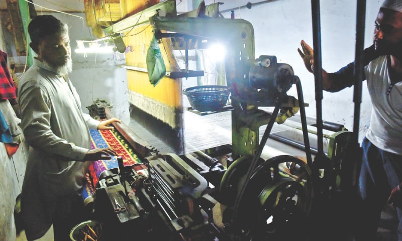 A MAN uses a Jacquard loom to weave Banarsi cloth.—Fahim Siddiqi / White Star A MAN uses a Jacquard loom to weave Banarsi cloth.—Fahim Siddiqi / White Star