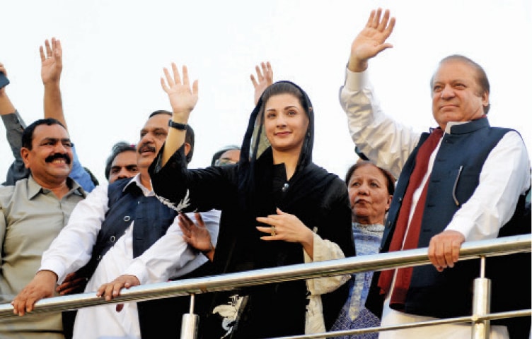 PML-N Quaid Nawaz Sharif, Maryam Nawaz and Malik Abrar wave to the crowd during the workers convention in Islamabad on Monday. — Photo by Mohammad Asim