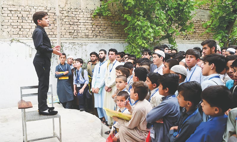 Elegantly dressed, his gestures confident, Hammad Safi gives a lecture at a language academy.&mdash;AFP