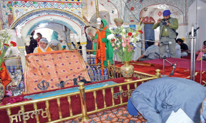 Sikh pilgrims perform their rituals at Gurdwara Punja Sahib on Saturday. — Dawn