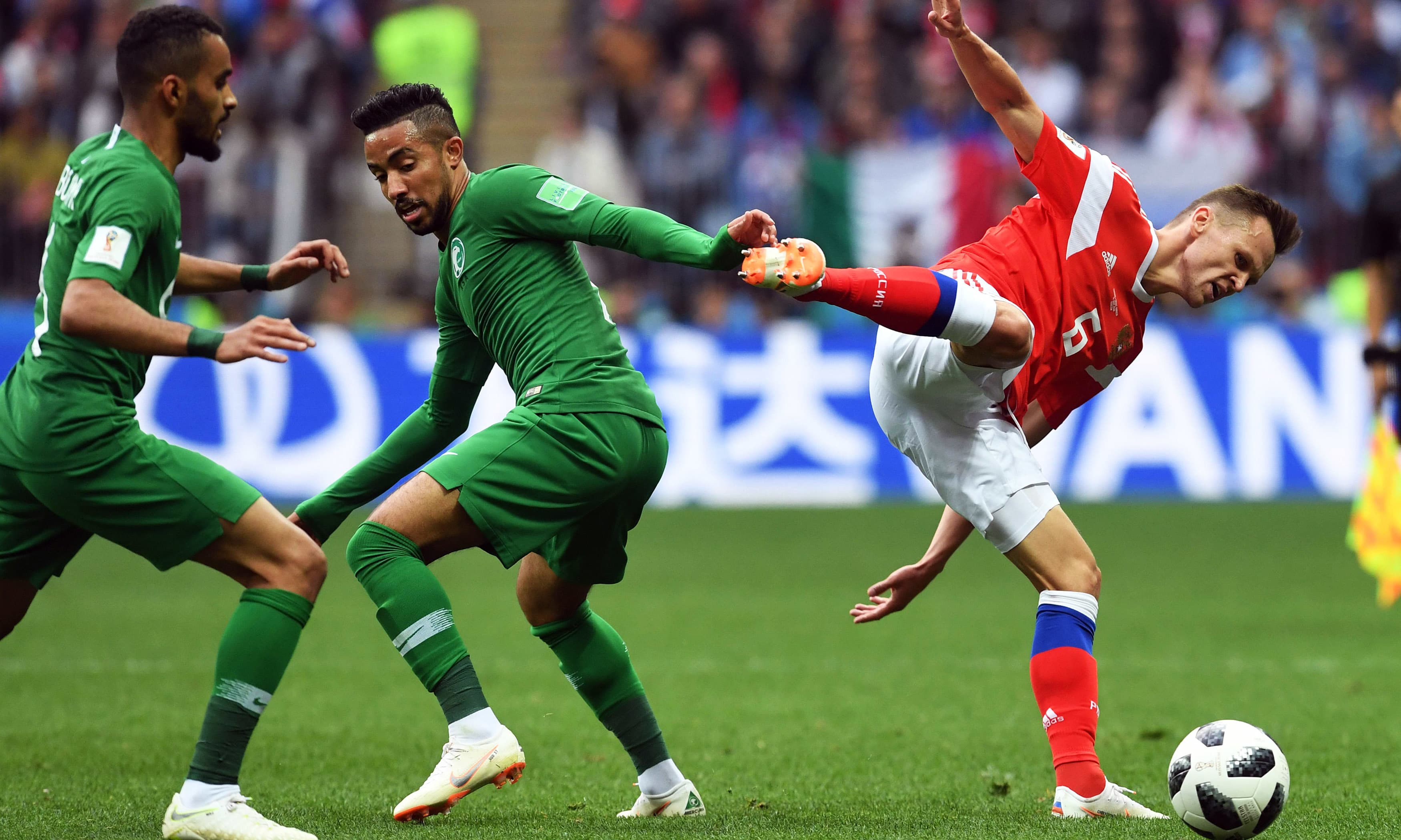 Saudi midfielder Hatan Babhir vies with Russia's midfielder Denis Cheryshev. —AFP