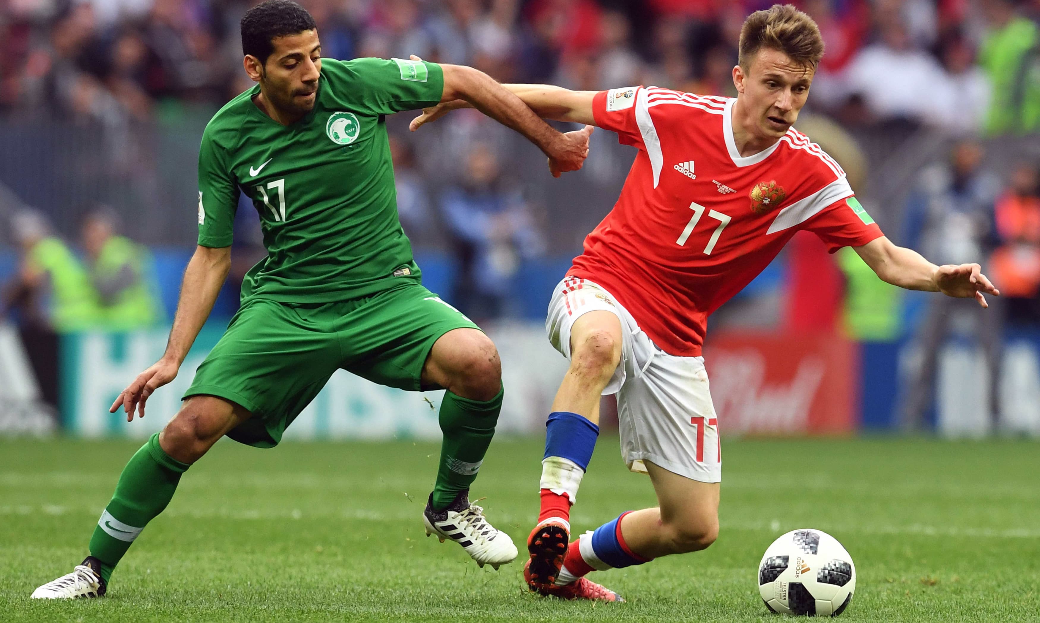 Taisir Al-Jassim vies with Russia's midfielder Aleksandr Golovin. —AFP