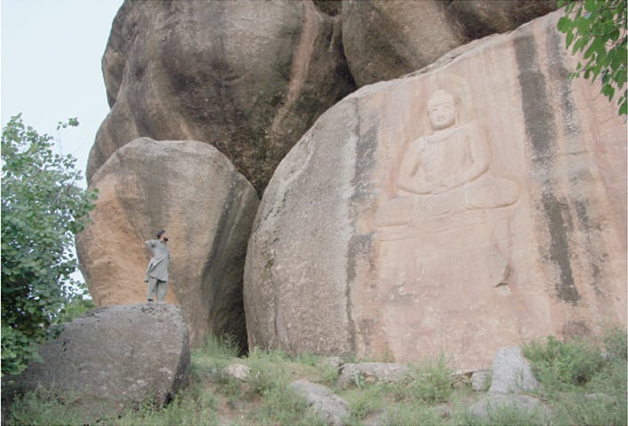 A magnificent Buddha keeps watch over the lower reaches of Swat