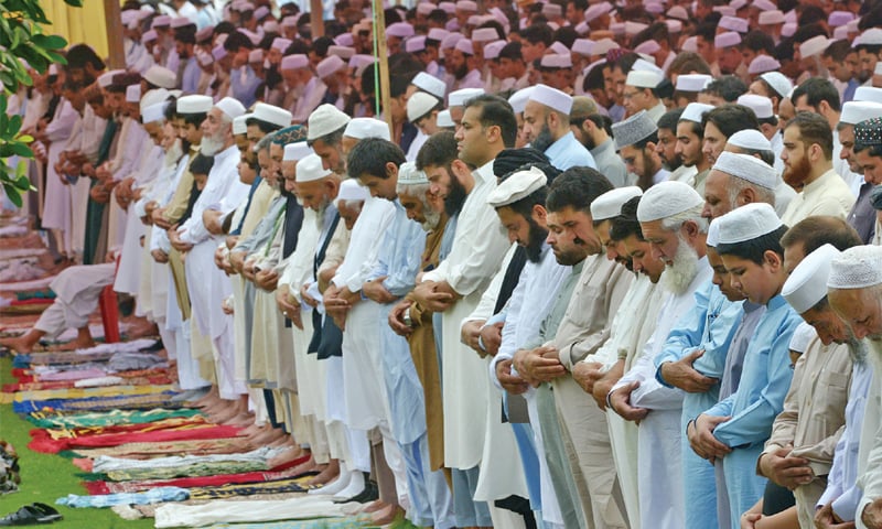 People offer Eidul Fitr prayers at Bagh-i-Naran, Peshawar, on Friday. — Photo by Abdul Majeed Goraya People offer Eidul Fitr prayers at Bagh-i-Naran, Peshawar, on Friday. — Photo by Abdul Majeed Goraya