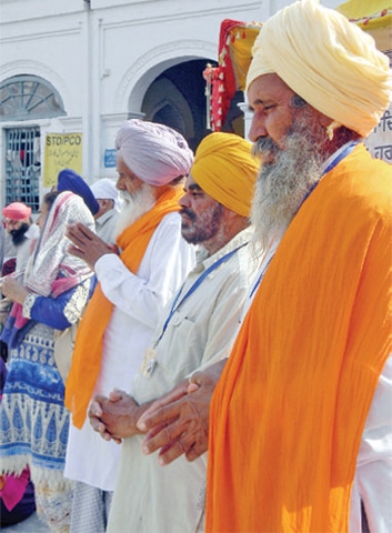 Indian Sikh pilgrims perform their rituals at  Gurdwara Punja Sahib in Hassanabdal on Friday. — Dawn