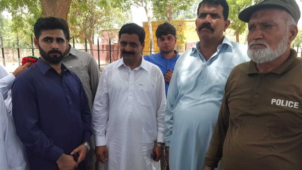 Mahar Sattar in handcuffs in front of the ATC in Sahiwal's Farid Town area. ─ Photo courtesy author
