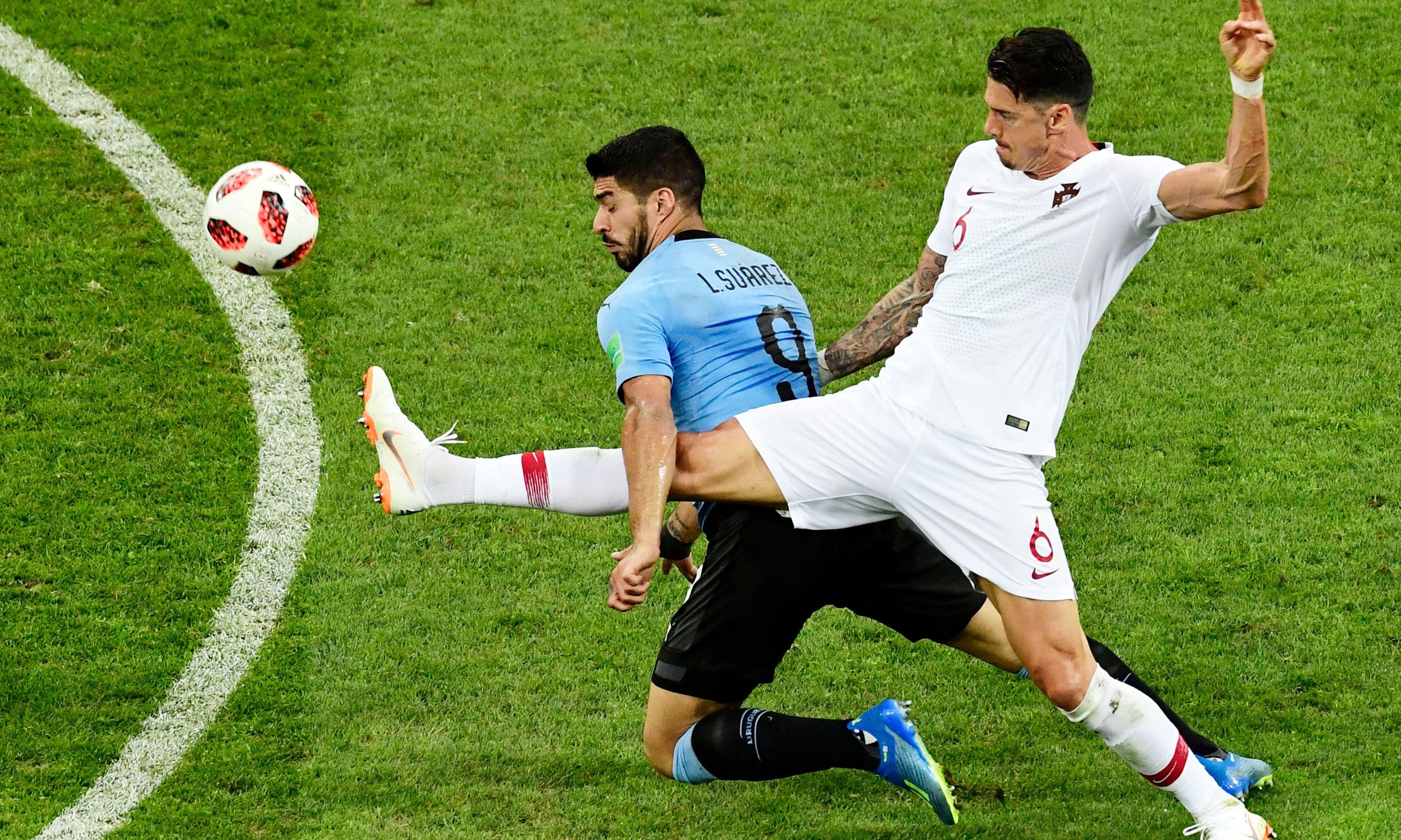 Luis Suarez challenges Portugal's defender Jose Fonte during the Russia 2018 World Cup round of 16 football match. &mdash;AFP