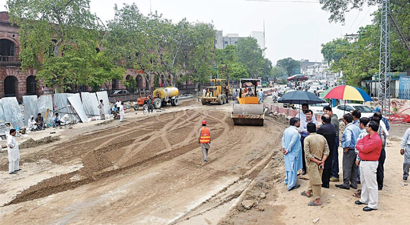 The road at GPO Chowk is being levelled after filling sinkholes which appeared during heavy rain on Tuesday. — White Star The road at GPO Chowk is being levelled after filling sinkholes which appeared during heavy rain on Tuesday. — White Star