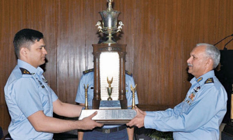 SARGODHA: Air Chief Marshal Mujahid Anwar Khan awards Chief of the Air Staff Trophy for the Best Combat Commander to Wing Commander Fahad Sajid Peerzada. &mdash; Dawn
