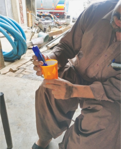 A MAN uses a digital instrument to measure if the groundwater he has access to is drinkable or not.—Photo by writer