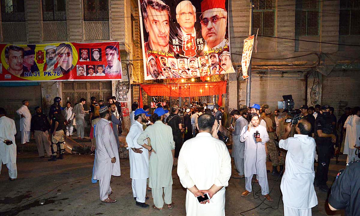 People gather near the blast site following a suicide attack on ANP corner meeting in the Yakatoot area. —APP