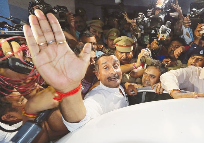 A FILE photo of Kuldeep Singh Sengar, a legislator of Uttar Pradesh state from India’s ruling Bharatiya Janata Party, reacts as he leaves a court after he was arrested on Friday in connection with the rape of a teenager in Lucknow on April 14.—Reuters