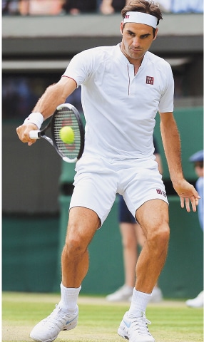 LONDON: Switzerland’s Roger Federer plays a return against Kevin Anderson of South Africa during their Wimbledon quarter-final on Wednesday.—AFP