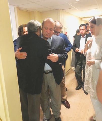 LONDON: Ousted prime minister Nawaz Sharif hugs a family member before leaving his home for the airport on Thursday as his daughter Maryam looks on. His son Hussain is also seen.