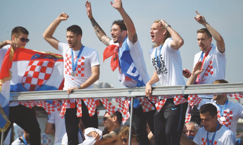 CROATIAN team members ride an open-roof coach in Zagreb after their return from the World Cup on Monday.&mdash;AFP