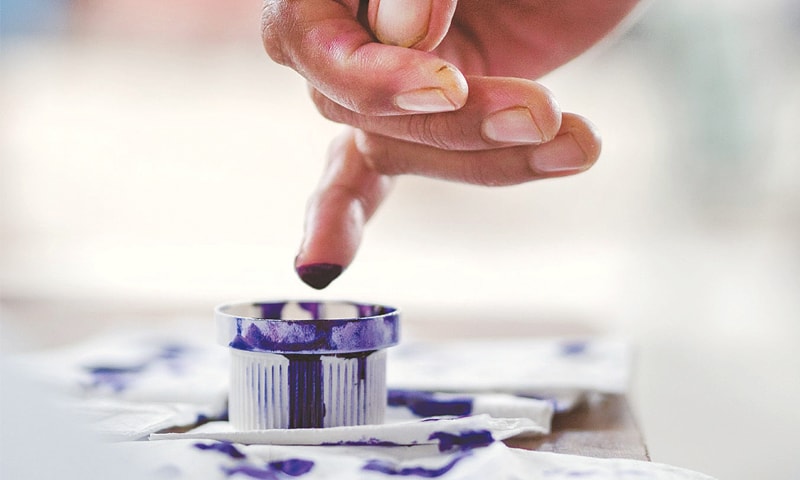 A MAN dips his finger in indelible ink in East Denpasar, Bali, after voting in the Bali gubernatorial election. More than half of the country’s population cast their ballots in the simultaneous regional elections on June 30.
—The Jakarta Post