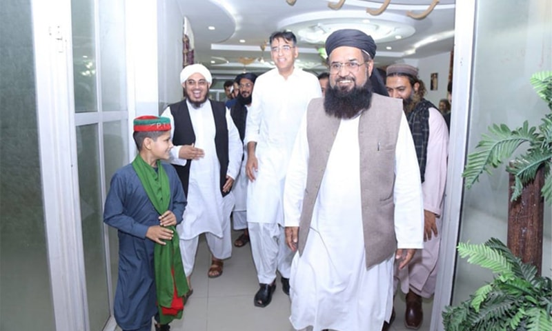Maulana Khalil leaves the marquee where he met Asad Umar.