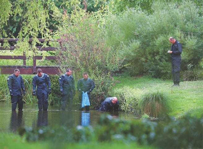 Salisbury: Police officers search a river in Queen Elizabeth Gardens on Thursday.—Reuters