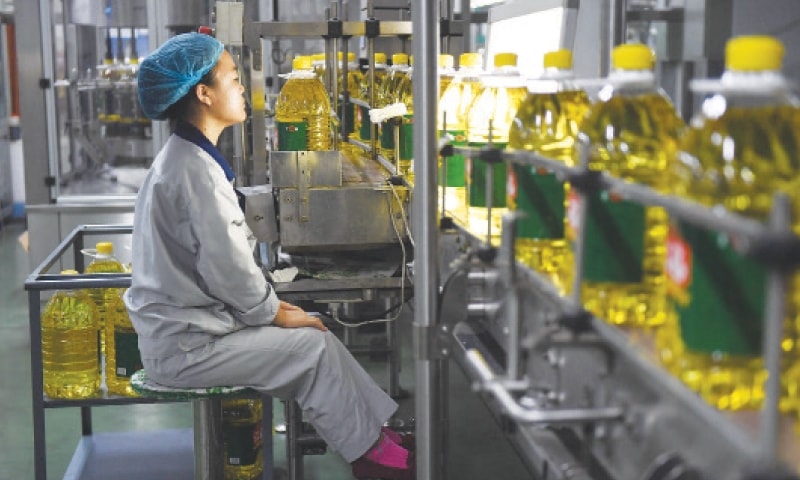 This photo shows a worker monitoring a soybean oil production line at a factory in Sanhe, in China’s northern Hebei province.—AFP This photo shows a worker monitoring a soybean oil production line at a factory in Sanhe, in China’s northern Hebei province.—AFP
