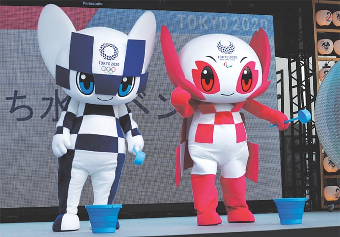 2020 Olympic Games mascot Miraitowa and Paralympic mascot Someity holds ladle to splash water during an old Japanese tradition called Uchimizu ritual on Tuesday prior to a countdown event to mark the two years until the Tokyo Olympics.—Reuters