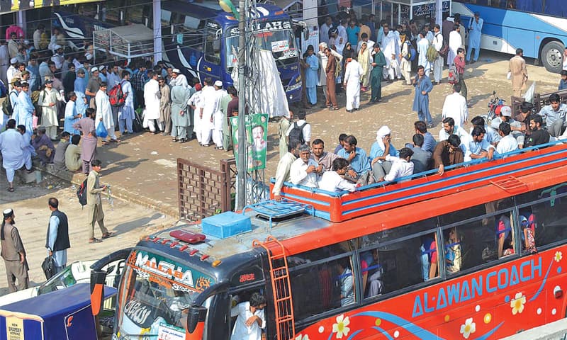 People queue up for tickets at a terminal in Pirwadhai Mor to take a bus home for casting their votes. &mdash; INP