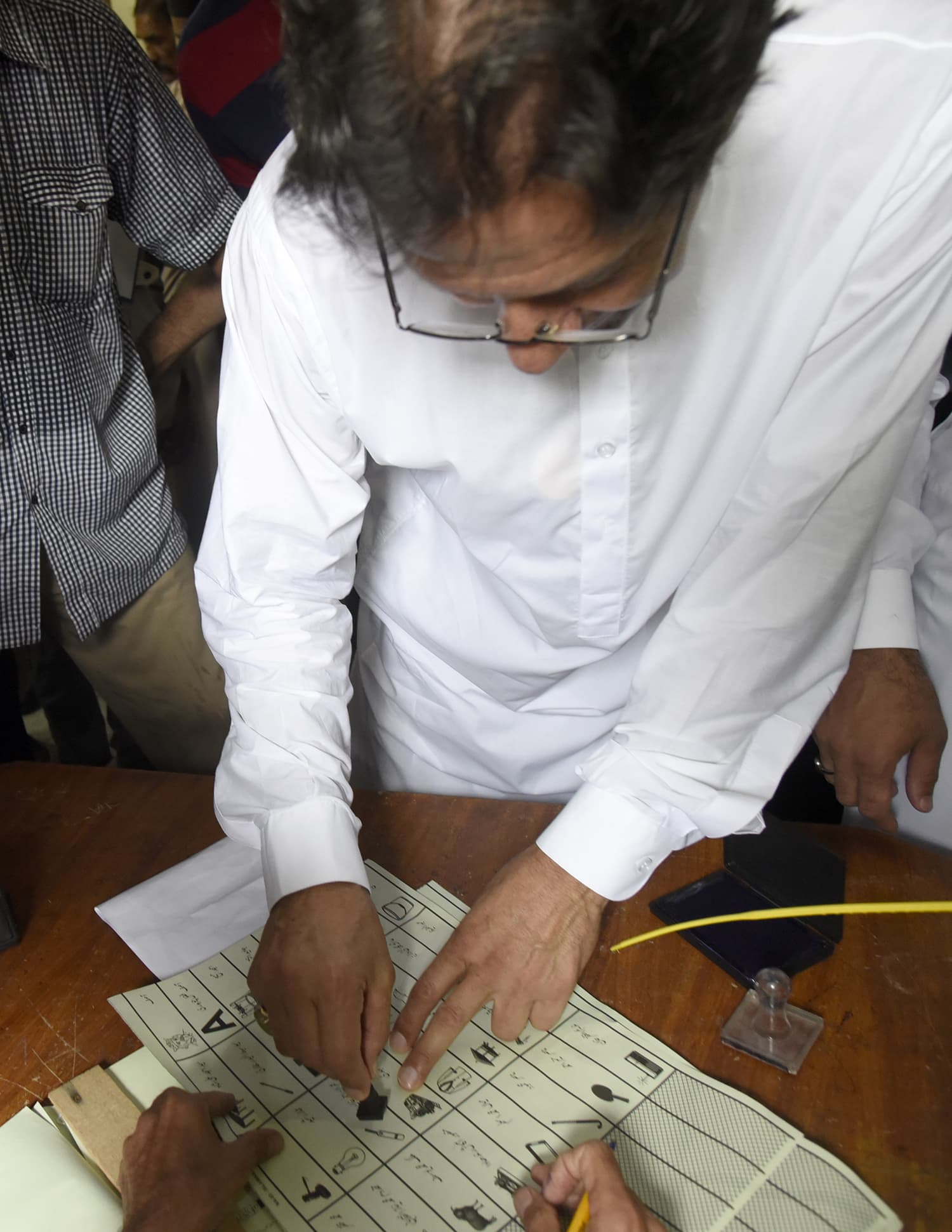 Imran Khan stamping his vote at Bhara Kahu.