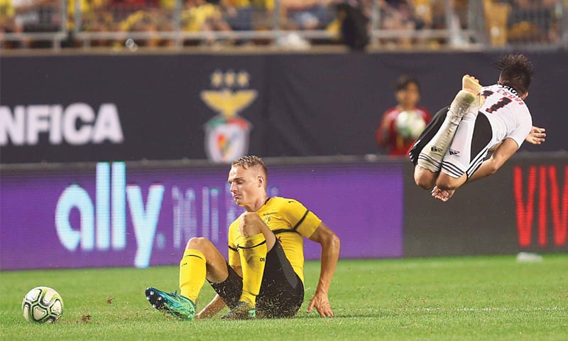 PITTSBURGH (Pennsylvania): Benfica Franco Cervi goes airborne after a slide tackle by Borussia Dortmund’s defender Amos Pieper at Heinz Field.—Reuters