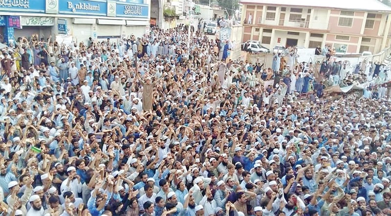 People chant slogans during protest in Battagram against alleged rigging in elections. The protesters have blocked Karakoram Highway for the last two days. &mdash; Dawn photo