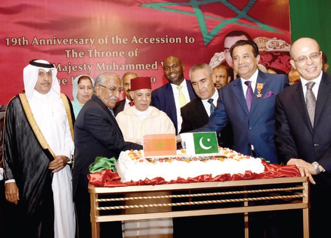 Ambassador Mohamad Karmoune, interim health minister Mohammad Yusuf Sheikh and other dignitaries cut the cake on Morocco’s National Day in Islamabad.