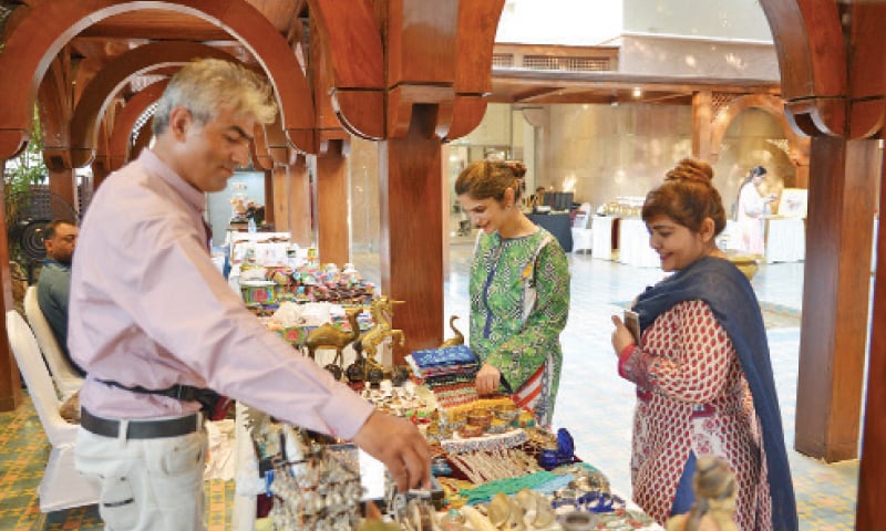 Visitors look at ornaments at a stall in the bazaar on Friday. The other pictures show footwear and honey on display. &mdash; Photos by the writer