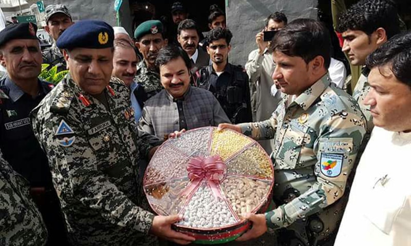 Afghan officials present sweets to Pakistani security personnel. — Photo by author