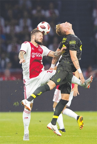 AMSTERDAM: Lasse Schone (L) of Ajax vies for the ball with Standard Liege’s Renaud Emond during their match at the Johan Cruijff Arena.—AFP