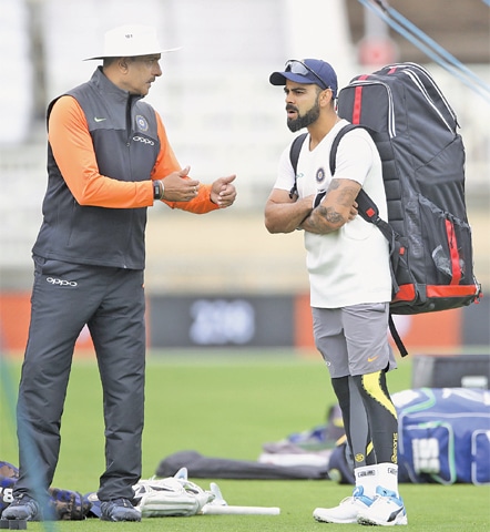 NOTTINGHAM: India’s head coach Ravi Shastri speaks with skipper Virat Kohli during a net practice session at Trent Bridge on Friday.—AP