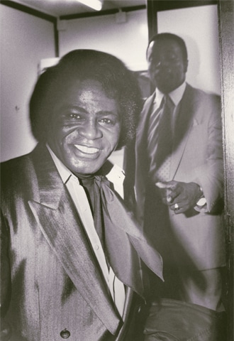 A 1988 backstage photo of James Brown with his bodyguard shadowing him