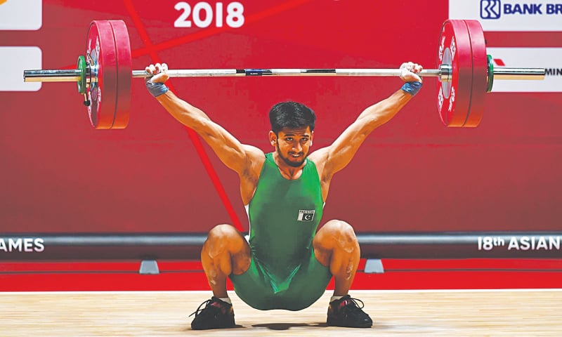 JAKARTA: Talha Talib of Pakistan competes in the men’s 62kg weightlifting event at the Asian Games on Tuesday.—AFP JAKARTA: Talha Talib of Pakistan competes in the men’s 62kg weightlifting event at the Asian Games on Tuesday.—AFP