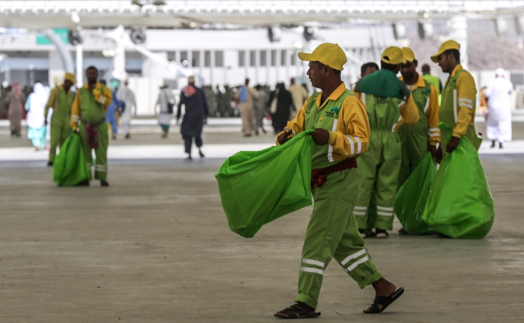 Sanitation workers collect litter during the annual Haj pilgrimage in Makkah on Wednesday. &mdash; AFP