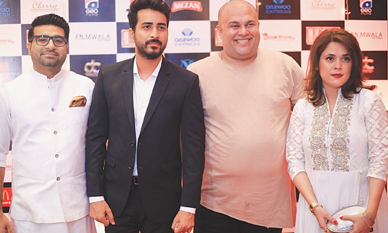 DIRECTOR Nabeel Qureshi (in black jacket) poses at the premiere.