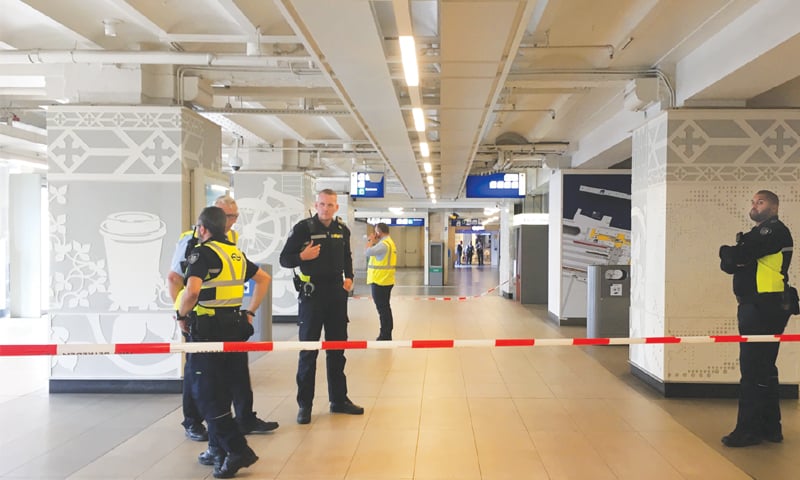 Amsterdam: Security officials cordon off an area inside the railway station after the stabbing.—AFP Amsterdam: Security officials cordon off an area inside the railway station after the stabbing.—AFP