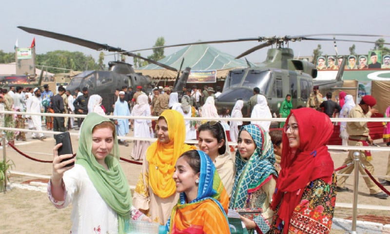 Visitors take selfies at a Defence Day exhibition in Peshawar. — INP Visitors take selfies at a Defence Day exhibition in Peshawar. — INP