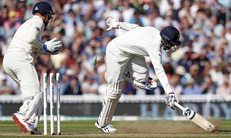 England's Jonny Bairstow (L) runs out India's Jasprit Bumrah (R) as the Indian Innings comes to a close. — AFP