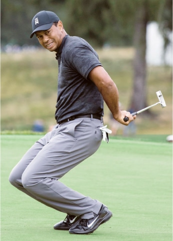 PHILADELPHIA: Tiger Woods reacts after missing a putt for a birdie on the fourth green during the BMW Championship at the Aronimink Golf Club in Newtown Square.—AP