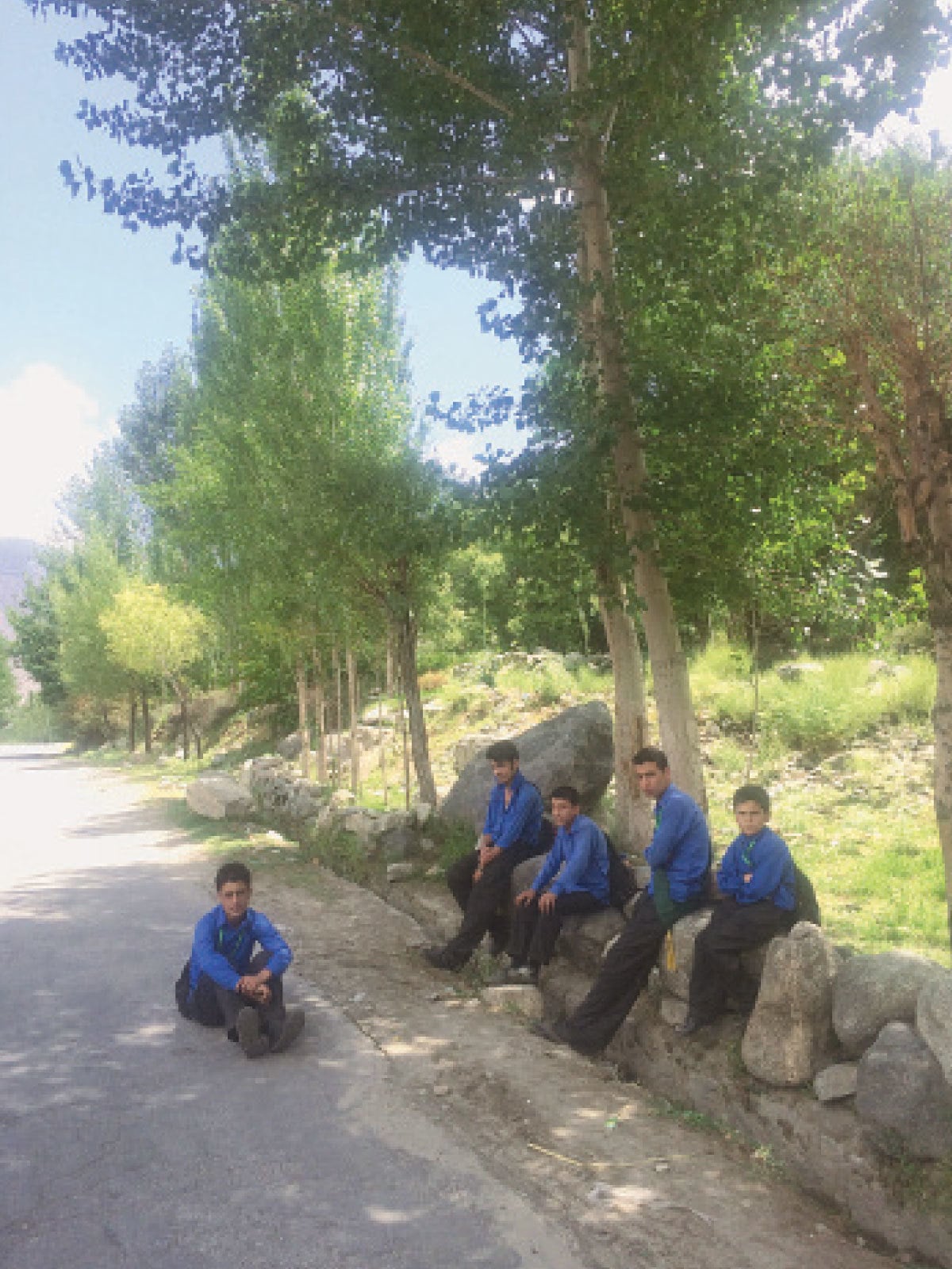 School boys rest along a roadside in Singul village on the Gilgit-Ghizer Road | Aurangzaib Khan