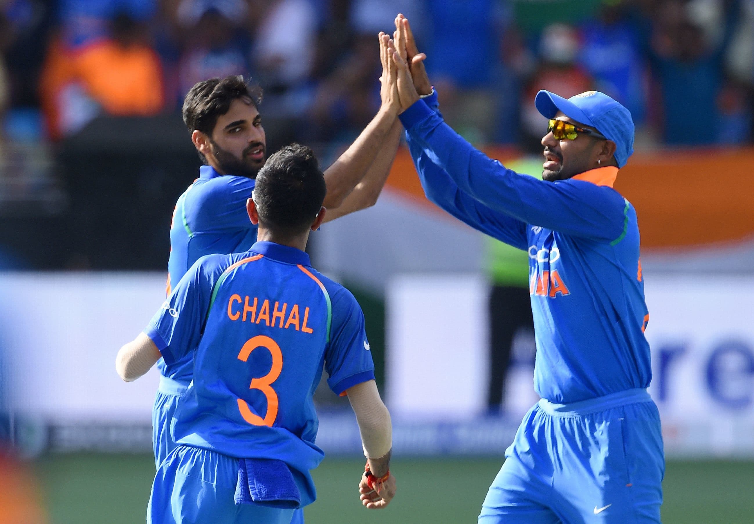 Indian cricketer Bhuvneshwar Kumar (L) celebrates with teammates after he dismissed Pakistan batsman Imam-ul-Haq. —AFP