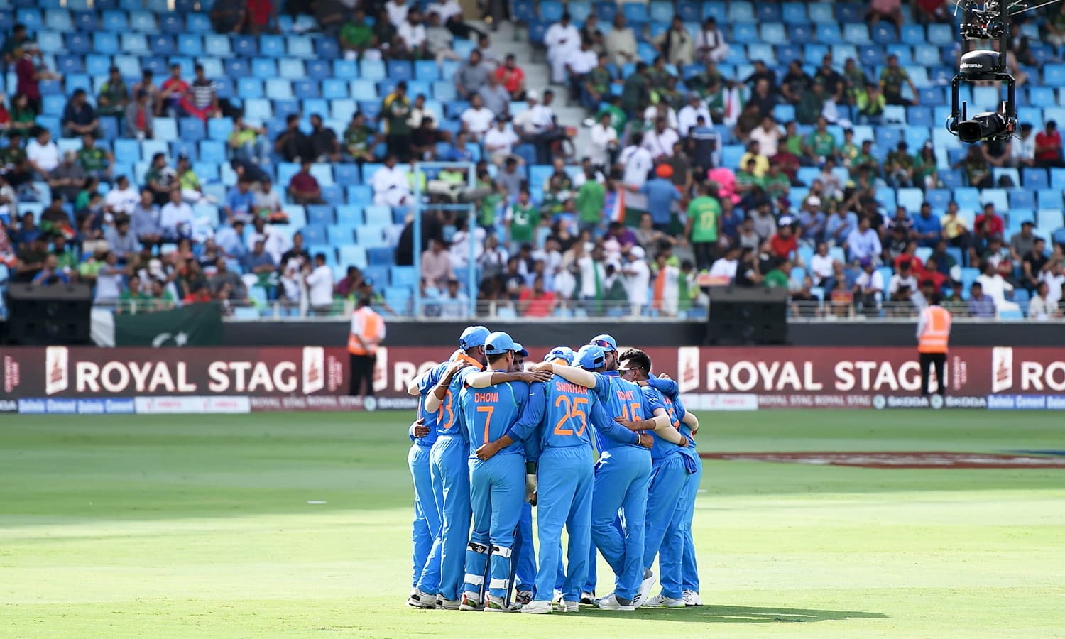 Indian team stand in a huddle before the start of the match between Pakistan and India at the Dubai International Cricket Stadium. — AFP