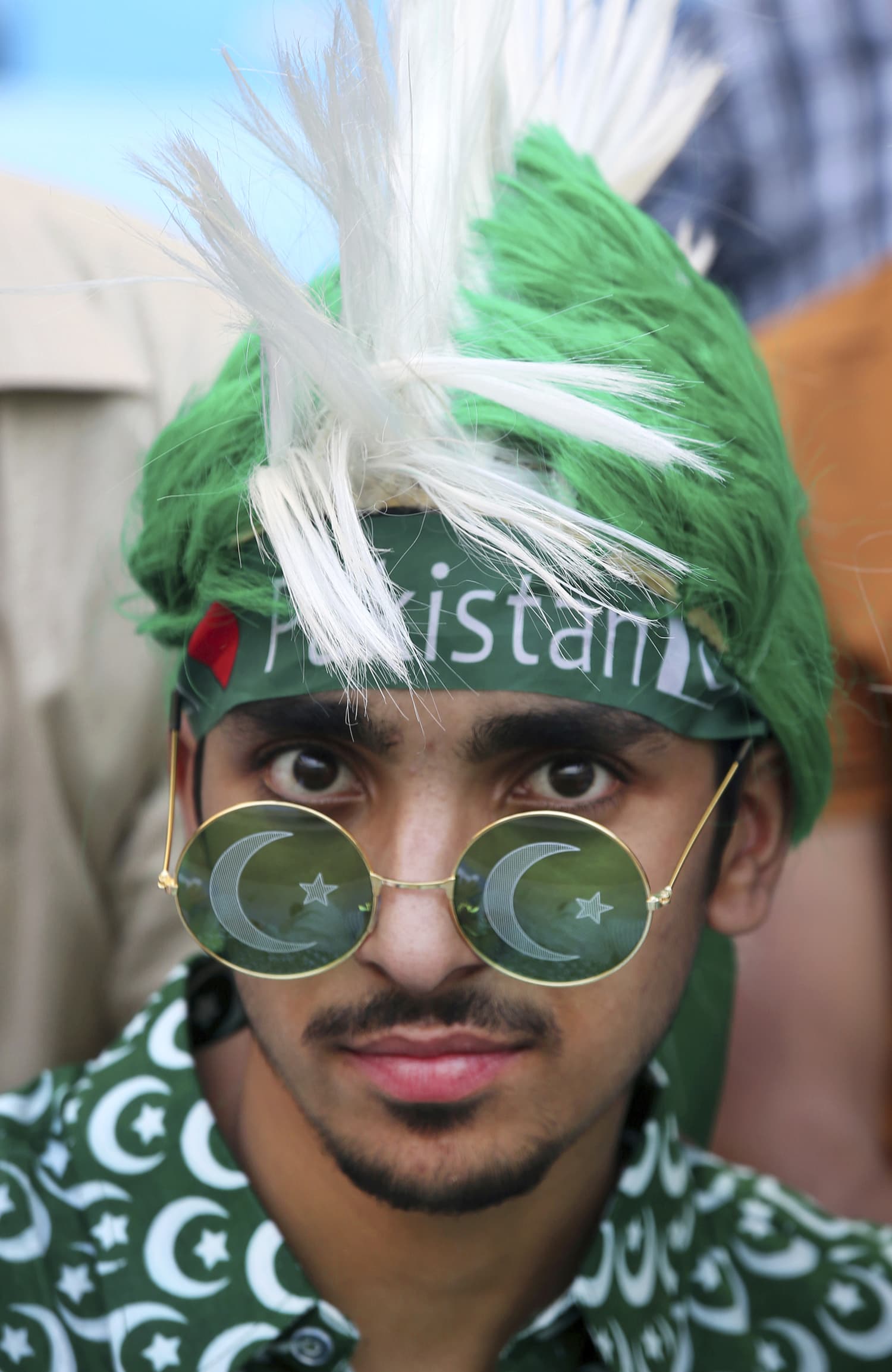 A Pakistani supporter sports a headgear and sunglasses as he waits for the start of the match. —AP.