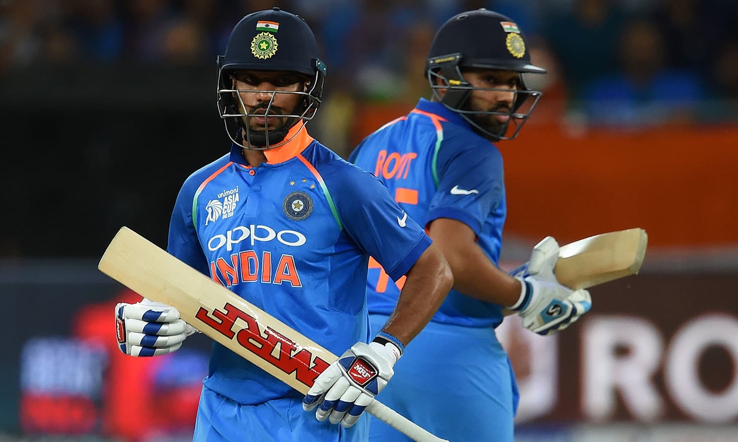 Indian cricket team captain Rohit Sharma (R) and Shikhar Dhawan runs between the wickets. —AFP